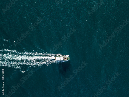 top view of fast travel boat going straight forward in the sea aerial shot