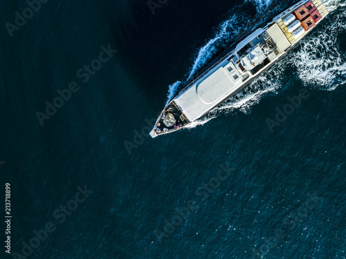 aerial top down view of travel ship nose part in the open sea © Mihail