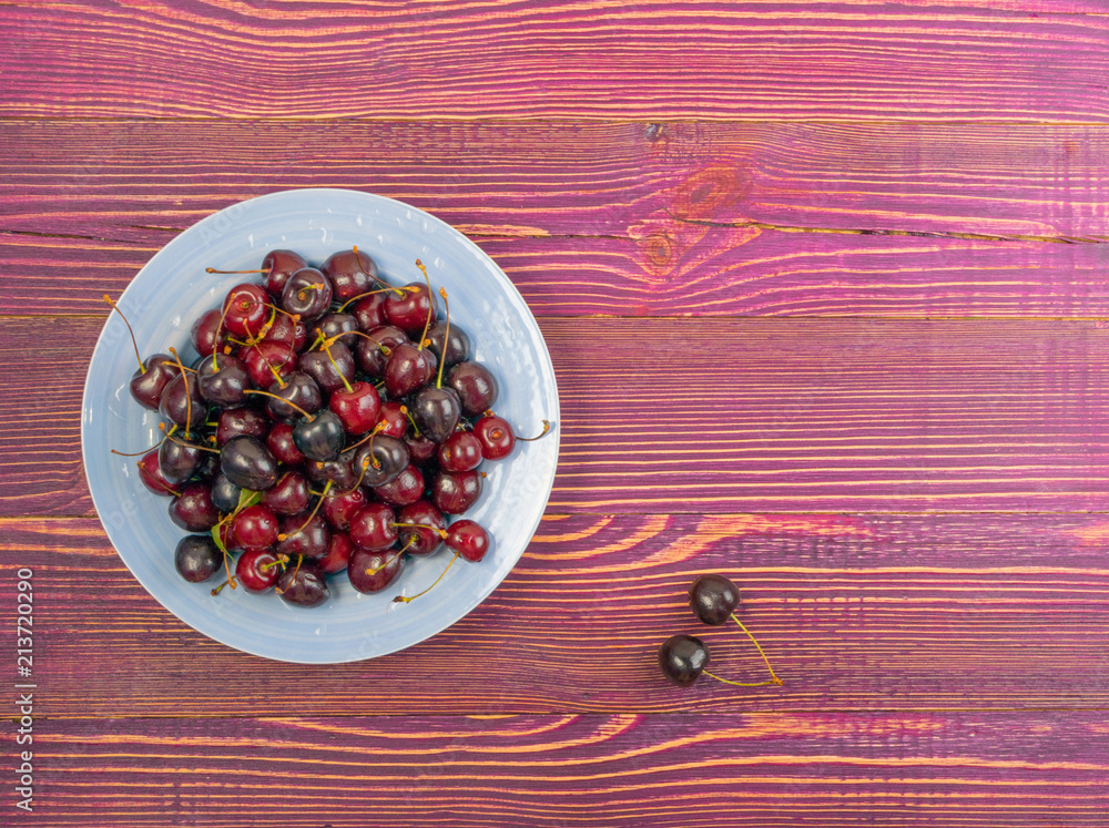 Fresh Overripe Cherry on Rustic Wooden Background Fresh Overripe Cherry on Rustic Wooden Background