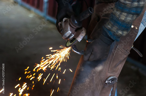 Blacksmith grinding the metal