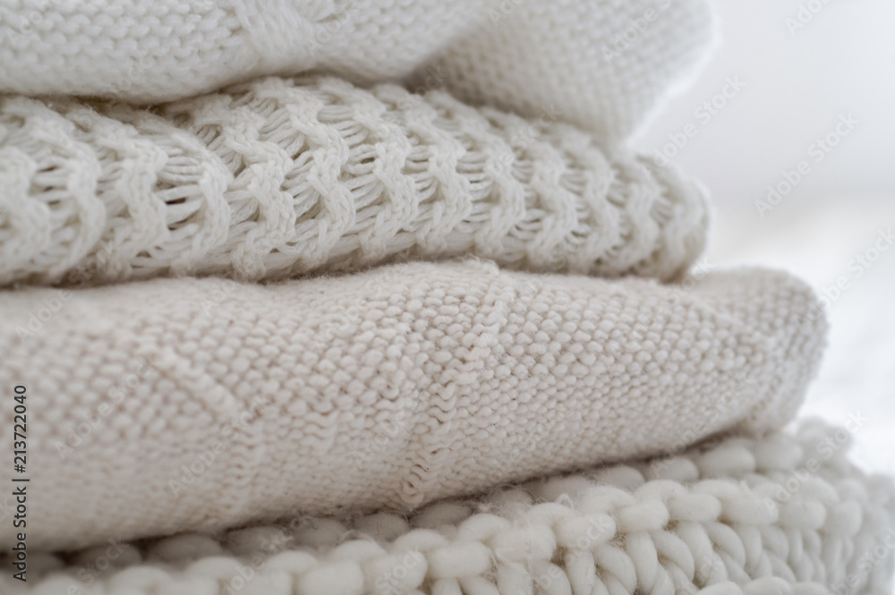 Background with warm sweaters. Pile of knitted clothes in warm shades, space for text, Autumn winter concept. Copy Space. Background with warm sweaters. Pile of knitted clothes in warm shades, space for text, Autumn winter concept. Copy Space.