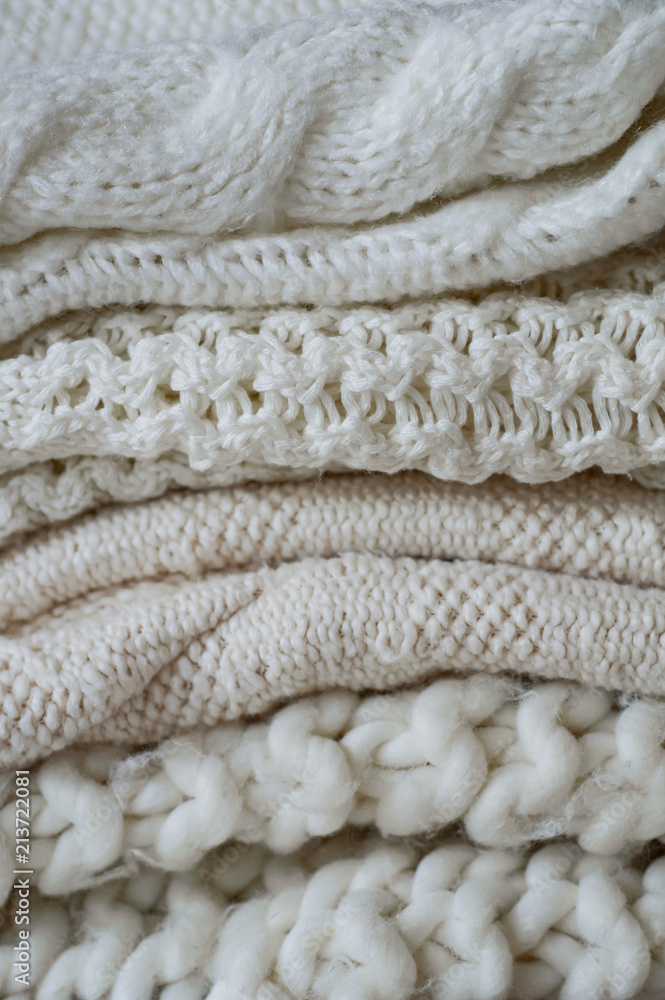 Background with warm sweaters. Pile of knitted clothes in warm shades, space for text, Autumn winter concept. Copy Space. Background with warm sweaters. Pile of knitted clothes in warm shades, space for text, Autumn winter concept. Copy Space.