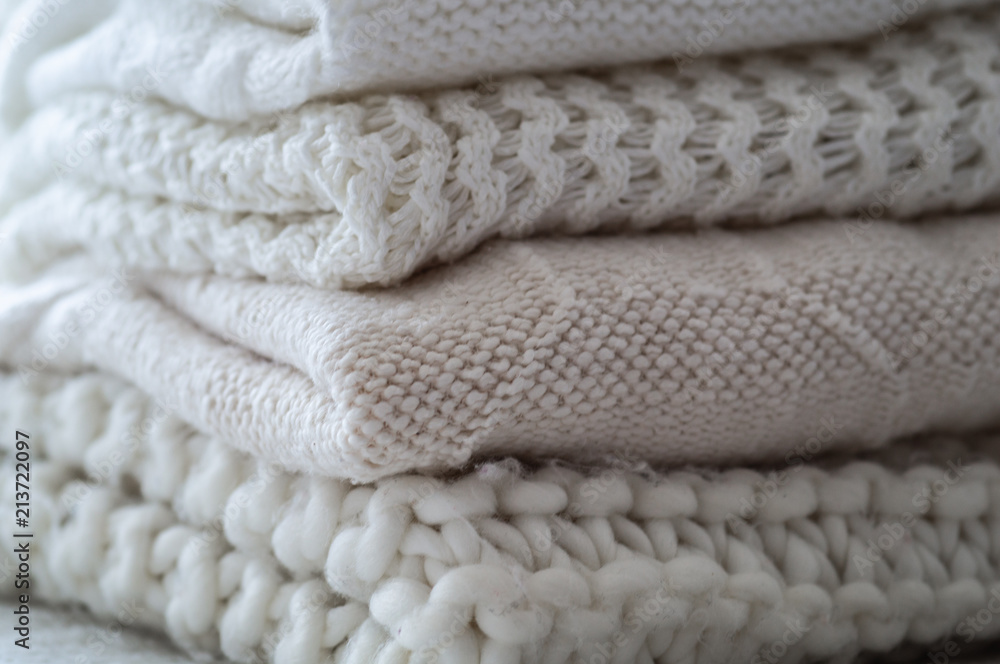 Background with warm sweaters. Pile of knitted clothes in warm shades, space for text, Autumn winter concept. Copy Space. Background with warm sweaters. Pile of knitted clothes in warm shades, space for text, Autumn winter concept. Copy Space.