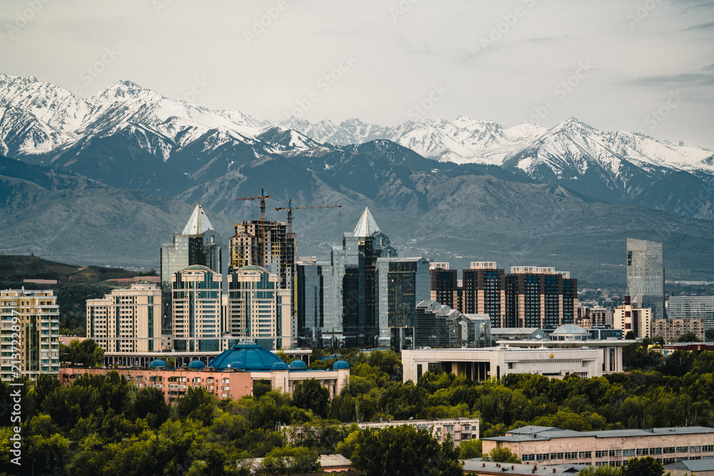 City Landscape On A Background Of Snow capped Tian Shan Mountains In city-landscape-on-a-background-of-snow-capped-tian-shan-mountains-in