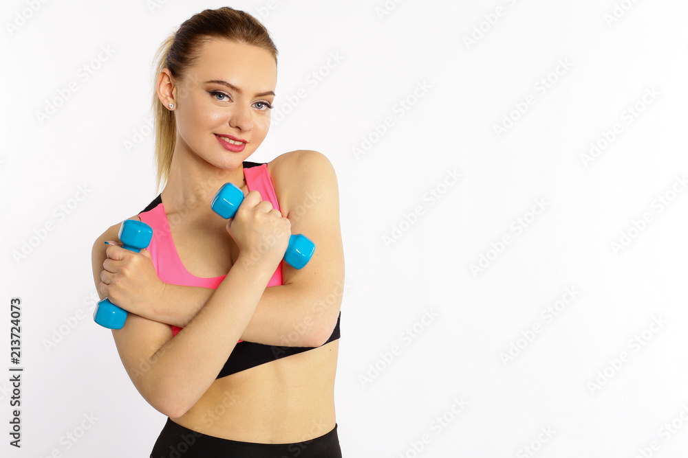 Young girl athlete, fitness with dumbbells isolated on white background Young girl athlete, fitness with dumbbells isolated on white background