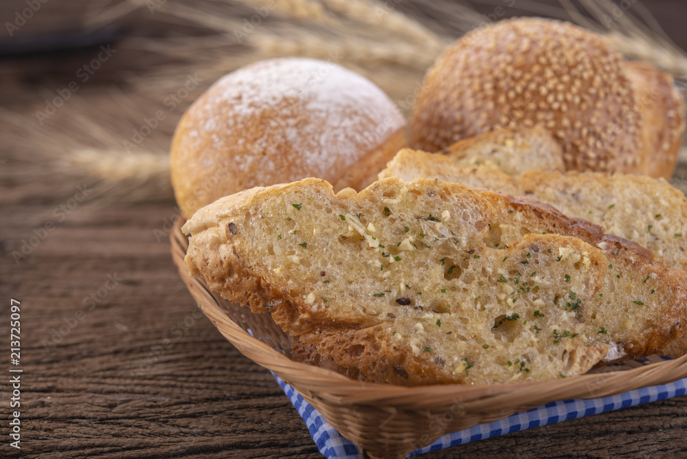 set of bread in bamboo basket on wooden background