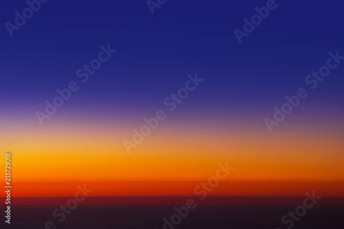 Sunset sky from the airplane window at height 35,000 feet. © Pina