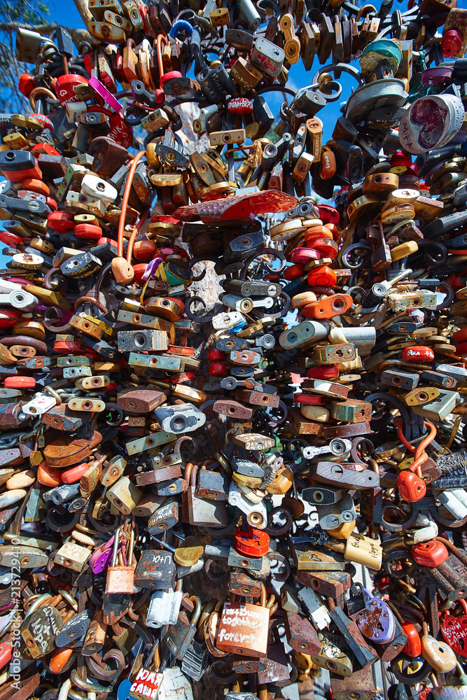 Multi-color wedding castles on the fence of the bridge.  The concept of loyalty, strong marriage, love for life.