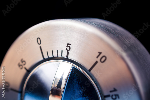 5 Minutes - Macro Of An Analog Chrome Kitchen Timer With Dark Background