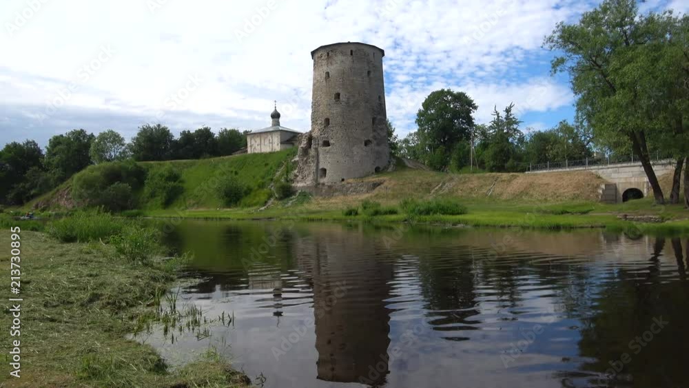 The old tower on the Pskov river on a cloudy June day. Pskov, Russia The old tower on the Pskov river on a cloudy June day. Pskov, Russia