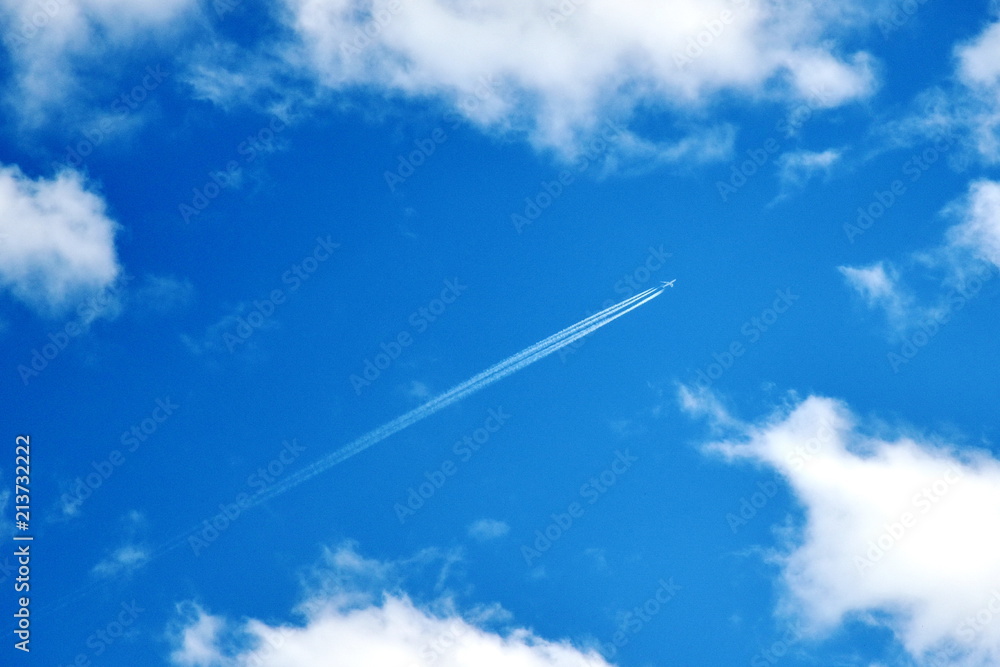 jet smoke and deep blue sky white clouds