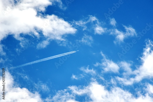 jet smoke and deep blue sky white clouds