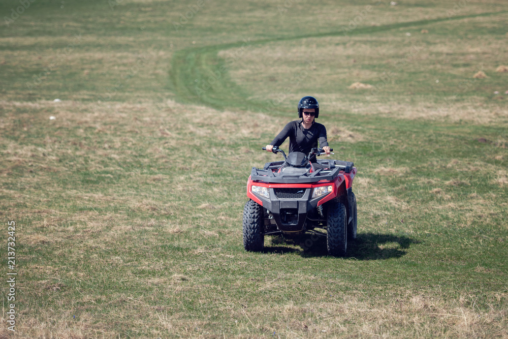 man riding atv vehicle on off road track ,people outdoor sport activitiies theme man riding atv vehicle on off road track ,people outdoor sport activitiies theme