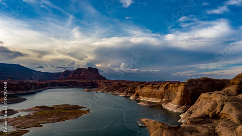 Aerial view of Lake Powell near Navjo Mountain  San Juan River in Glen Canyon with colorful buttes  skies and water