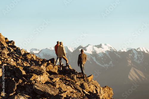 Happy friends having fun at sunset time in mountains range backdrop. Space for text