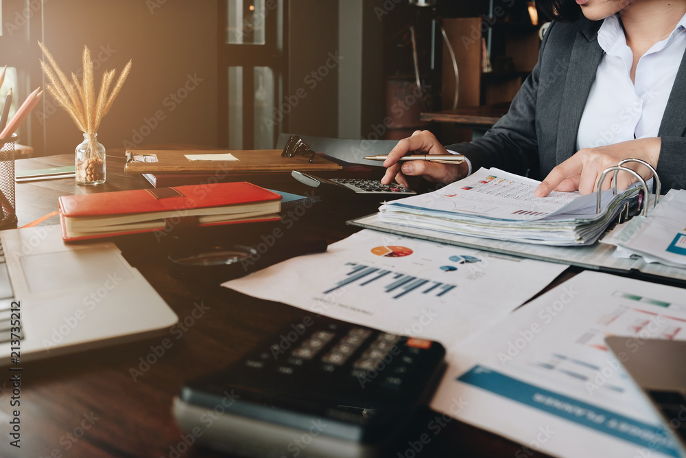 Businessman hands holding pen working on calculator and financial paperwork. Account and Saving concept. Businessman hands holding pen working on calculator and financial paperwork. Account and Saving concept.