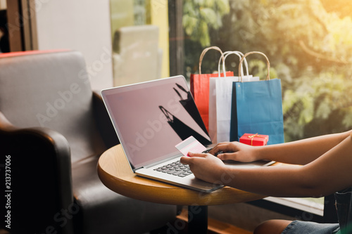 Women using laptop for shopping online and earn points to website.