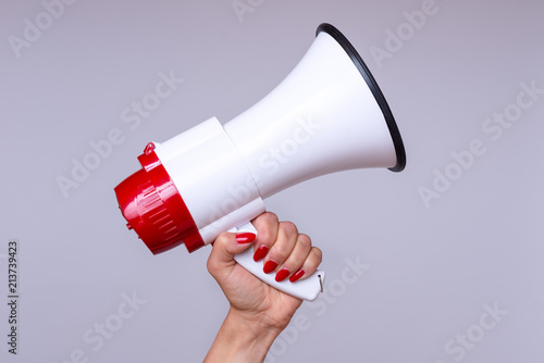 Woman holding up a loud hailer or megaphone photo