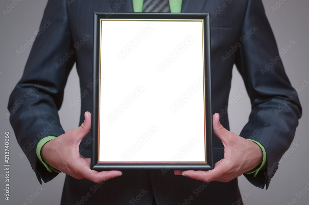 Blank diploma or certificate mock up in businessman hand. Empty photo frame border with copy space. Blank diploma or certificate mock up in businessman hand. Empty photo frame border with copy space.