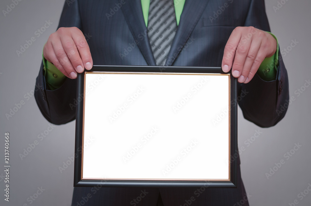 Blank diploma or certificate mock up in businessman hand. Empty photo frame border with copy space. Blank diploma or certificate mock up in businessman hand. Empty photo frame border with copy space.