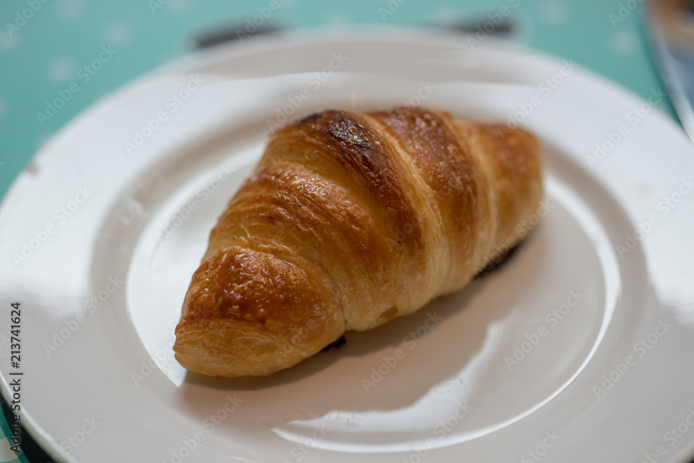 Plain croissant on white plate Plain croissant on white plate