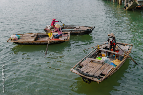 Three wooden boats with boatmen from Halong Bay. Vietnam photo