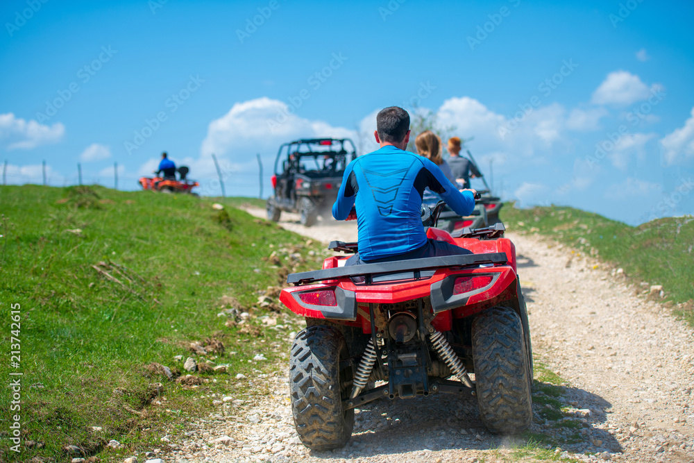 Obraz premium man riding atv vehicle on off road track ,people outdoor sport activitiies theme