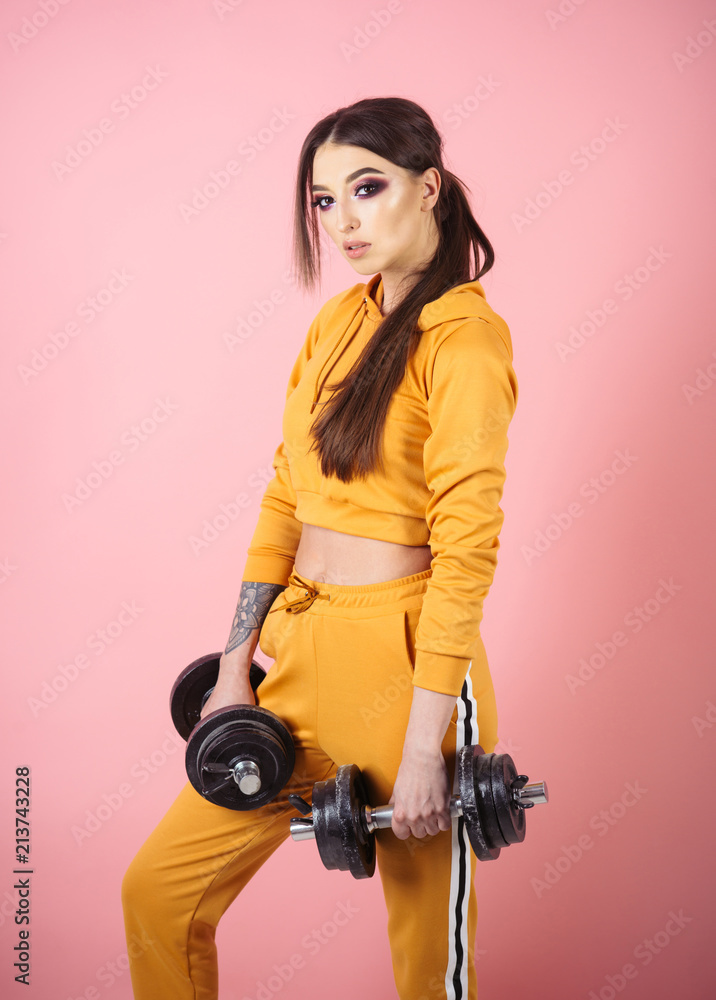 Naklejka premium workout. workout in gym. woman workout with barbells. workout sportswear concept.