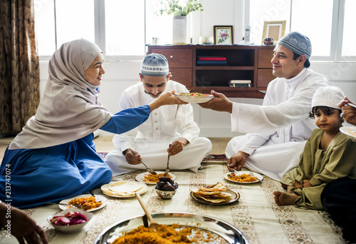 Muslim family having dinner on the floor photo