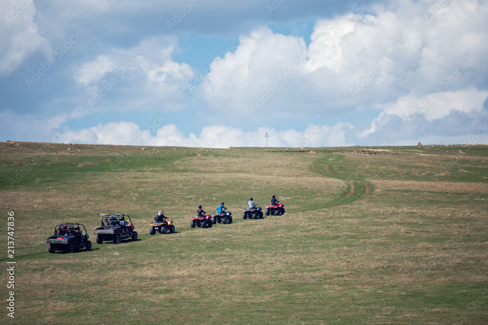 Obraz premium man riding atv vehicle on off road track ,people outdoor sport activitiies theme