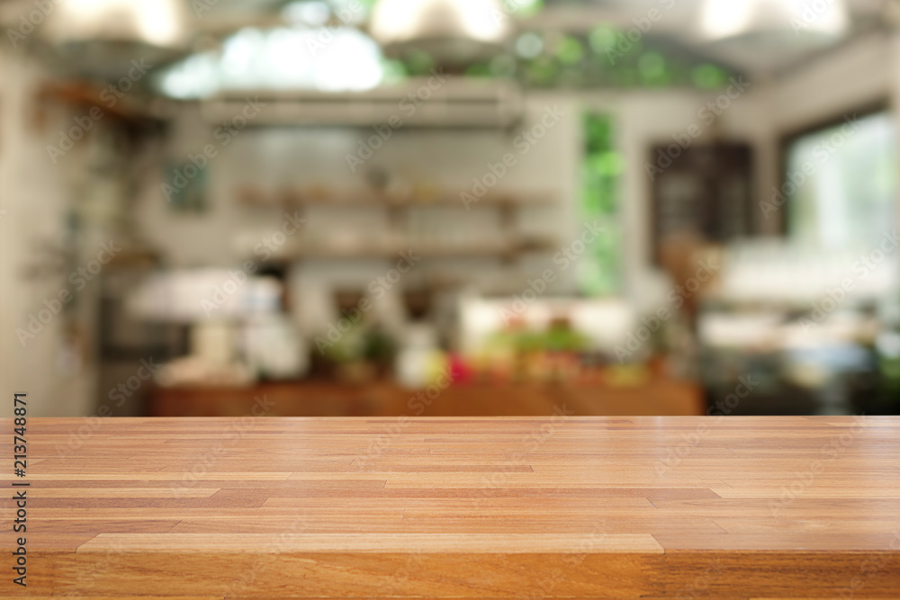 Empty of wood table top on blur of interoir coffee cafe background .For montage product display or design