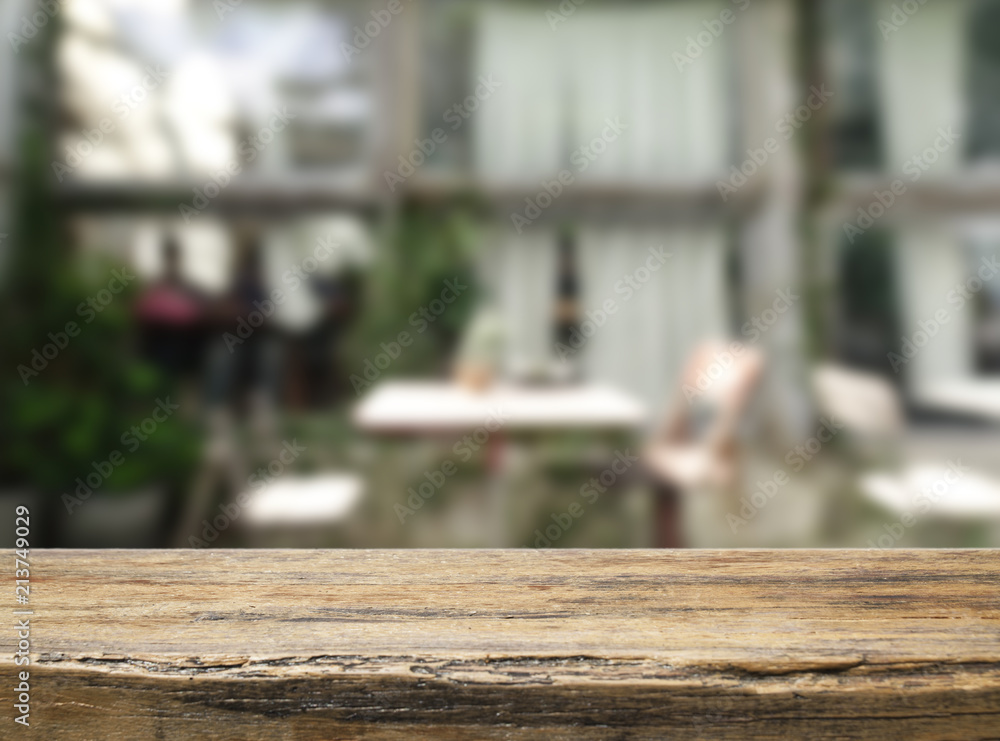 Empty wooden and table on abstract blurred background of coffee shop with shelf and window, product display, Ready for product montage.