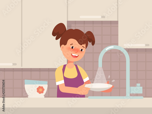Happy little girl wash the dishes in the kitchen