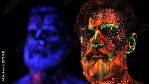 Three bearded men in UV powder are standing static photo