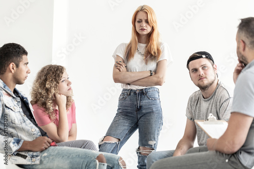 Difficult teenagers talking with psychologist during session in the office