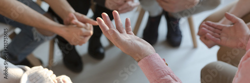 Panorama of therapist's hands while gesticulating during group therapy photo