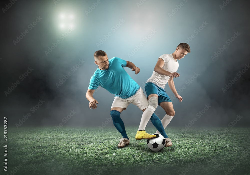 Naklejka premium Soccer player on a football field in dynamic action at summer day