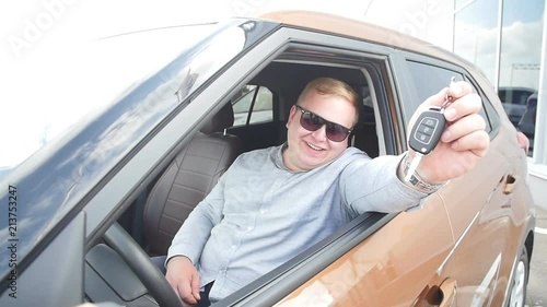 Happy man with keys from new car photo