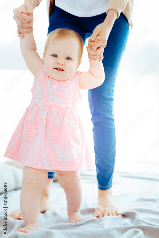 I did it. Charming kid keeping smile on face while making first steps I did it. Charming kid keeping smile on face while making first steps