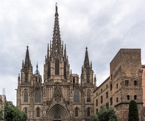 Neo-gothic facade of Barcelona Cathedral in the Gothic Quarter. Facade is decorated with statues  pinnacles  arches. The roof is notable for its gargoyles  featuring a wide range of animals.
