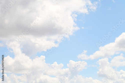 Blue sky with white beautiful clouds. The texture of natural phenomena  cloudiness on a clear sunny day.
