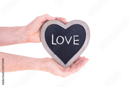 Adult holding heart shaped chalkboard