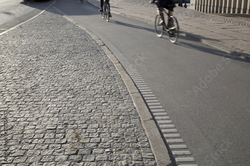 Cyclists on Cobblestone Street; Christianshavn; Copenhagen