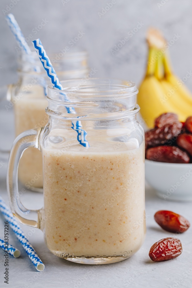 Banana and date fruit smoothie or milkshake in glass mason jar Banana and date fruit smoothie or milkshake in glass mason jar