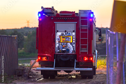 Photography Flashing lights of red fire truck at dusk