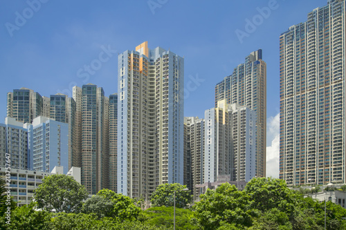 the modern megalopolis, high-rise houses and park zone against the background of the blue sky, the house and trees, modern architectural design, summer in Asia