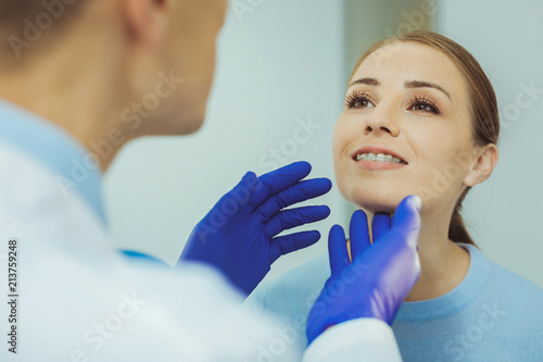 Monthly checkup. Attractive blonde expressing positivity while visiting doctor