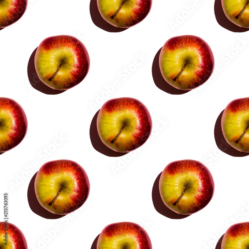Seamless pattern of apples on green background