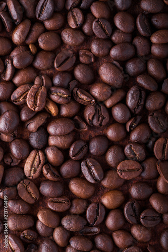 Photo closeup of coffee beans. Rusty background. Copy space.