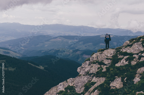Woman on mountain peak overlooking Carpathian Mountains